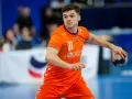 Kay Smits w pomarańczowej koszulce z numerem 31, gotowy do rzutu piłką ręczną.
