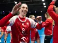Radosna zawodniczka w koszulce z numerem 8 świętuje zwycięstwo w meczu piłki ręcznej.