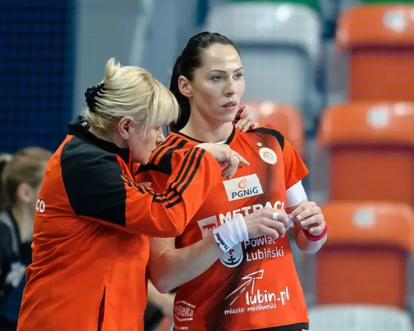 Wiktoria Jaroniewska w akcji podczas meczu piłki ręcznej. Trenerka udziela wskazówek zawodniczce.