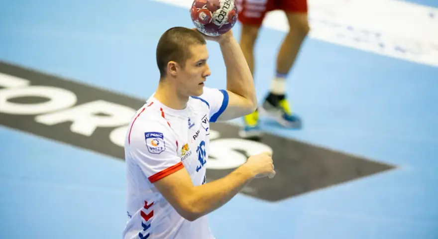 Wiktor Tomczak, zawodnik piłki ręcznej, przygotowuje się do rzutu.