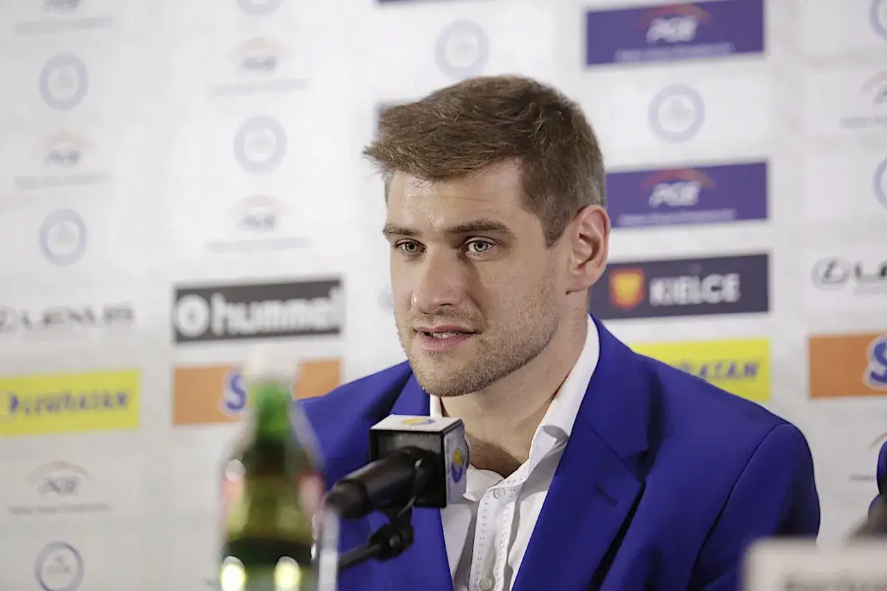 Julen Aginagalde, w niebieskiej marynarce, udziela wywiadu przed mikrofonem. W tle widoczne logo PGE i Kielce.