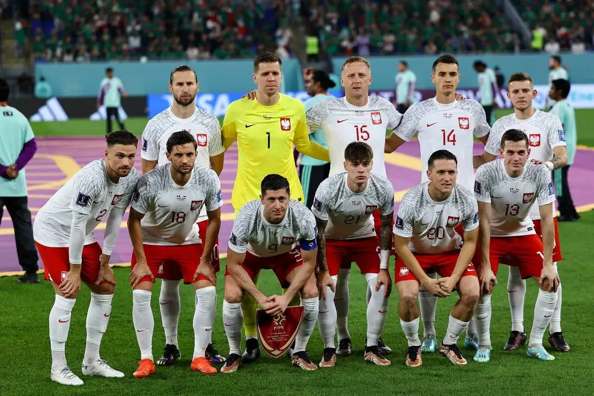 Reprezentacja Polski zawodnicy w białych strojach z orłem na piersi, gotowi do gry.