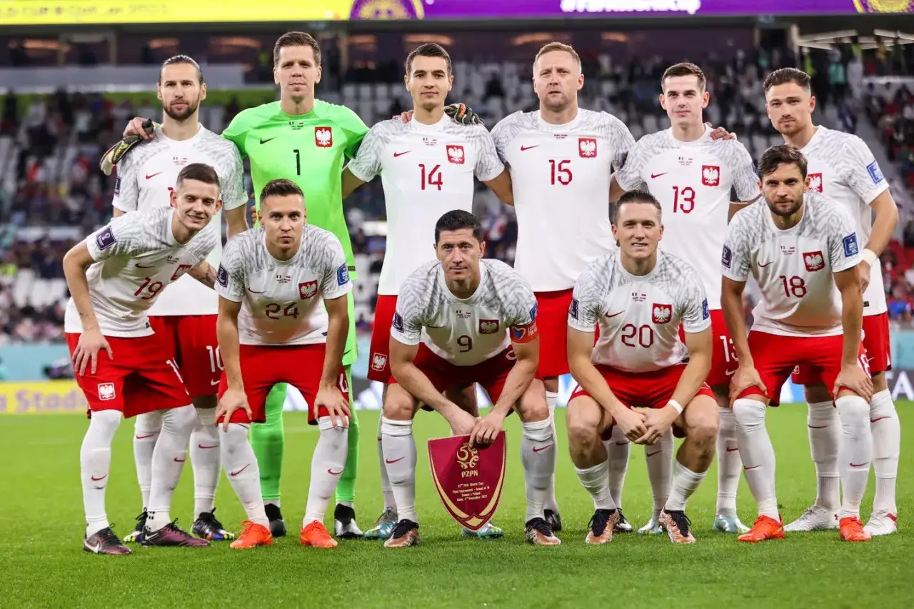 Polska reprezentacja piłkarska w strojach narodowych, gotowa do meczu z Francją. Skład drużyny z numerami na koszulkach.