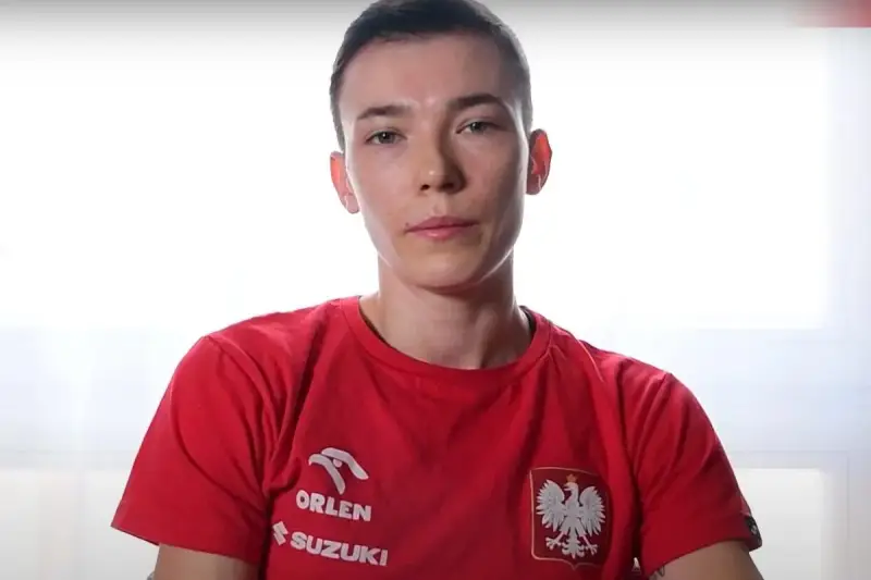 Młoda kobieta, Magda Balsam, w czerwonej koszulce z orłem i logiem Orlen.